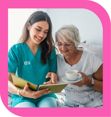 Caregiver spending time with senior at home, reading together and providing companionship