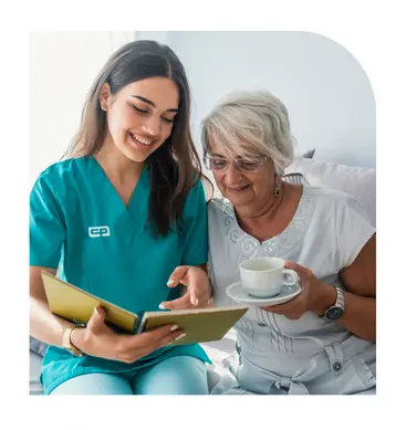 Caregiver reviewing a booklet with a senior woman receiving home care support