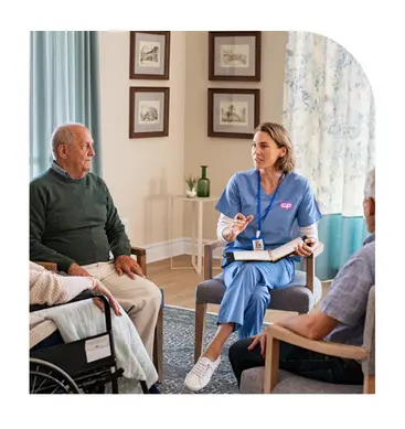 Caregiver speaking with senior clients while planning home care support